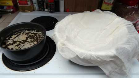 Line a bowl with two layers of cheese cloth, we'll be using this to strain out the plant matter from the butter