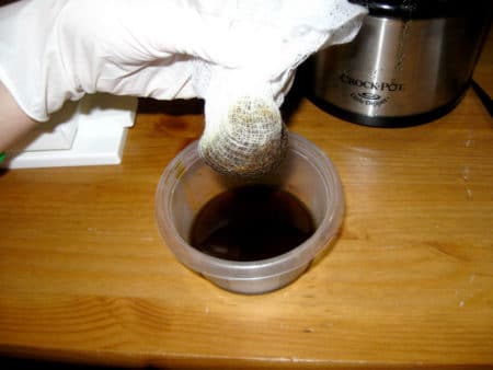 Cannabis bundled up in cheesecloth before being pressed