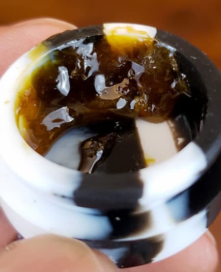 Fresh marijuana rosin in a small "dab" container