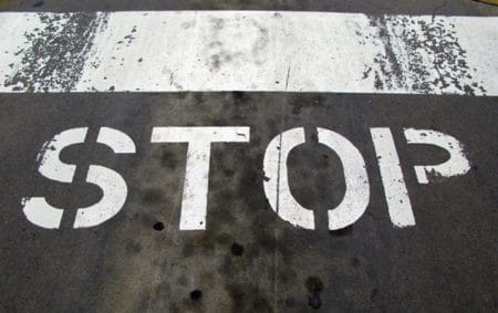 "Stop" painted on a oily road