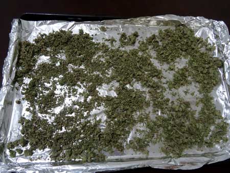 Sprinkle the ground up bud over your cookie sheet so it's all spread out