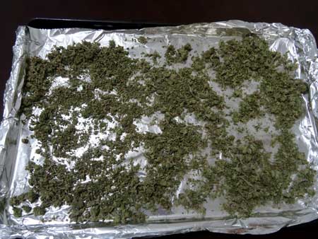 Sprinkle the ground up cannabis over your cookie sheet so it's all spread out.