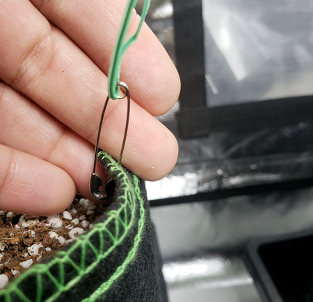A safety pin can be used to secure twist tie to your fabric plant pot