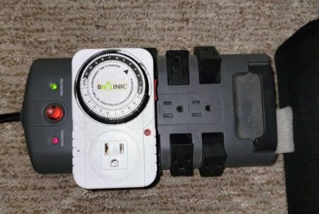 An electrical timer plugged into a surge protector